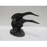 An unusual bog oak Statue, depicting two swans resting on a naturalistic base, approx.