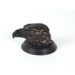 A 19th Century bronze Inkwell, modelled as the head of an eagle mounted on a stepped circular base,