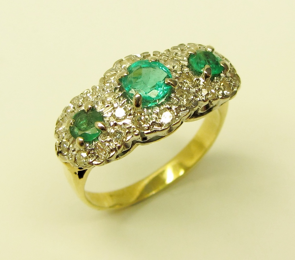 An attractive three stone emerald Ring,