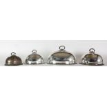 A suite of four silver plated Victorian graduating Dish Covers, monogrammed DM.