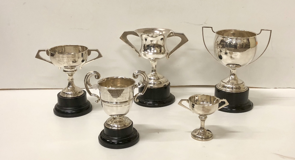 Five varied two handled silver Trophy Cups, various sizes, mostly Dublin c.