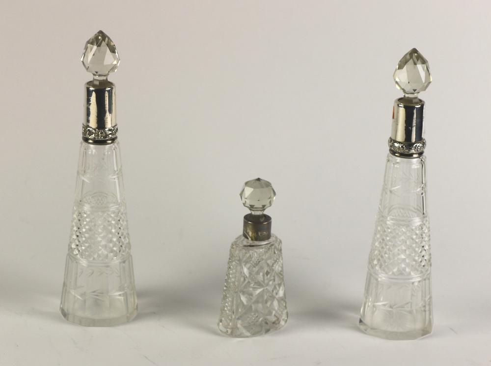 A small pair of silver mounted cone shaped cutglass Decanters & Stoppers;