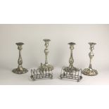 Plateware: A box containing two pairs of plated Candlesticks, , two Toast Racks, silver plated Mugs,