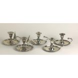 A set of three early 19th Century Chamber Candlesticks, with shaped handles,