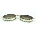 An attractive pair of oval shaped glass lined silver Butter Dishes, with two forks.
