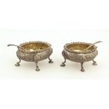 A pair of Victorian silver Salts, embossed with floral decoration and pad feet,