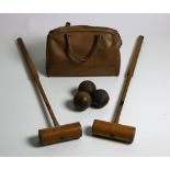 A collection of Croquet Mallets,; together with some Bowling Balls in satchels.