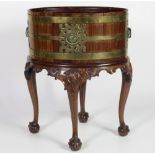 A good Georgian style mahogany oval Wine Cooler on stand, with brass bound decoration and liner,