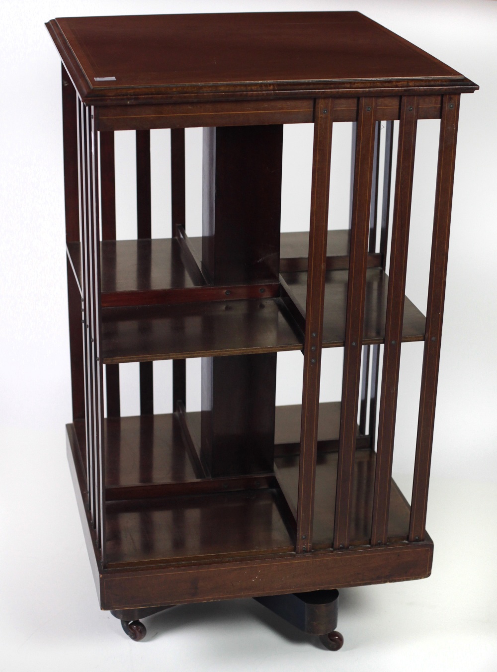 An attractive Edwardian Revolving Bookcase, with inlaid top and latted sides.