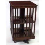 An attractive Edwardian Revolving Bookcase, with inlaid top and latted sides.