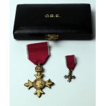 A cased silver gilt OBE Medal, with matching miniature by the Royal Mint,