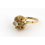 A 18ct gold Edwardian Dress Ring, with a large central stone and six stones surrounding, size L 1/2,