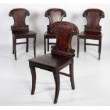 A set of 4 Irish William IV mahogany Hall Chairs, with shield shaped backs, decorative roundels,