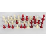 A 19th Century carved ivory Chess Set, with natural ivory and stained red ivory chess pieces,