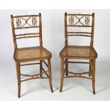 A pair of unusual Side Chairs, decorated in assimilated bamboo with cane work seats.