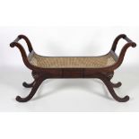 An Empire style rosewood Window Stool, with cane work seat, scroll arms and legs, approx.