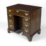 An attractive 18th Century period walnut kneehole Bachelors Desk, with crossbanded top,