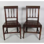 A pair of 19th Century mahogany spindle back Side Chairs, on H stretchers.