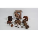 A large herd of Elephants, various sizes, in teak, mahogany and other Oriental woods, etc.