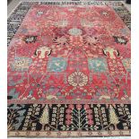 A fine quality Persian 20th Century claret ground Carpet, with a large floral decorated centre,