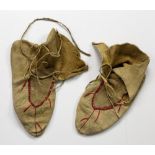Tribal Art: A rare pair of 19th Century Native American hide Moccasins,
