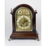 An Edwardian oak and brass dial German Bracket Clock for Morath Bros.
