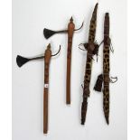 A pair of African engraved steel Axes, with decorated wooden handles,