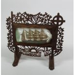A 20th Century Irish carved wooden framed Prisoner of War Craft, decorated with shamrocks and harps,