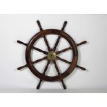 A heavy mahogany Ships Wheel, with eight turned spokes and handles,and brass centre cog, approx.