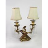 An attractive rococo decorated heavy ormolu two branch Table Light, with cutglass drops.