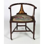 An Art Nouveau inlaid horse shoe Armchair.