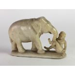 An early 19th Century Middle Eastern alabaster Carving, modelled as an elephant with figure, approx.