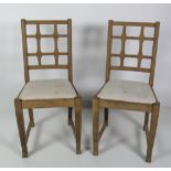 An unusual set of 14 heavy oak Dining Chairs, in the Arts & Crafts taste,