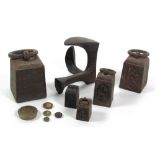 An antique set of 9 graduating iron Weights with ring handles, 4 ozs - 28lbs, some brass weights,