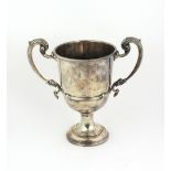 A large plain silver Trophy Cup, with two dragon decorated handles, and plain uninscribed body,