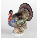A Royal Vienna Figure modelled as a Turkey Cock with colourful decoration and with beehive mark on