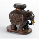 A good quality carved wooden Oriental Stand, modelled as an elephant in ceremonial robes, approx.