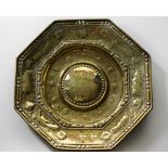 An unusual large embossed octagonal brass Alms Dish, probably 17th Century,