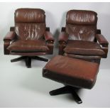 Two modern Eames type Armchairs, covered in brown leather, together with a matching Footstool.