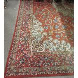 A large red ground and floral decorated Donegal Carpet, with a central medallion and corner designs,