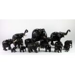A large herd of antique ebony Elephants, some large and some small, some with ivory tusks, approx.