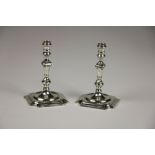 An unusual pair of cast silver taper Candlesticks, in the George II style, London 1976,