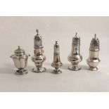 Four antique silver pillar Pepper Shakers, and another Shaker.