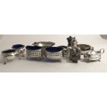 A pair of circular Chester silver Salts, with three pad feet, and blue glass liners,