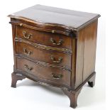 A Georgian style serpentine fronted Chest, of three drawers with brush and slide, on bracket feet,
