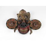 An early 19th Century Oceanic painted Tribal Figure with feather like crown, enlarged circular ears,