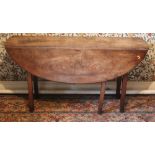 A 19th Century mahogany drop-leaf Dining or Wakes Table, with D shaped flaps on gate leg mechanism,