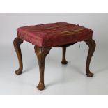 A George II period mahogany framed Footstool, with padded top on cabriole pad feet,