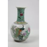 A Chinese porcelain and polychrome Bottle Vase, decorated with Phoenix, flowers and calligraphy,