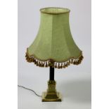A Corinthian column decorated brass Table Lamp, with ebonised reeded pillar and with green shade.